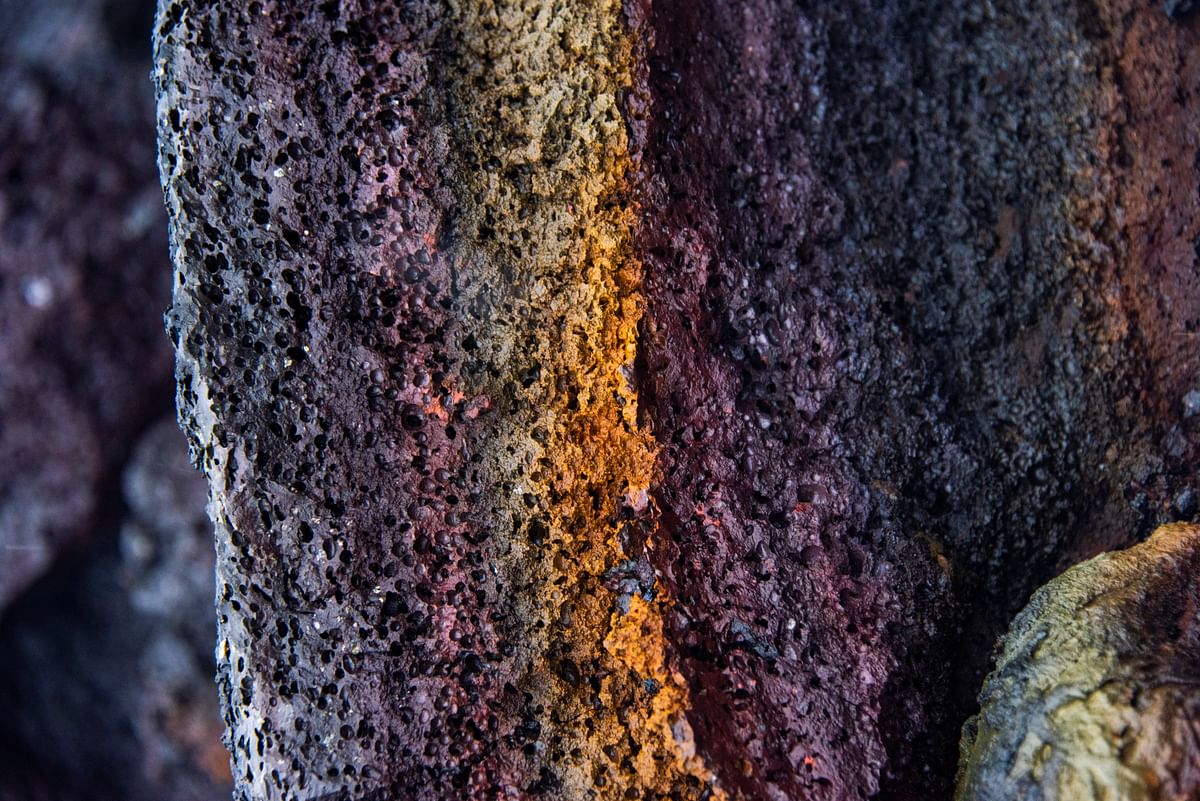 Close-up of multicolored volcanic rock textures, showcasing intricate natural patterns and vibrant hues.